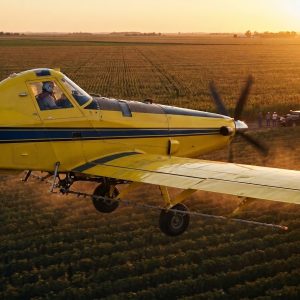 Crop_duster_flying_over_field_202608181709