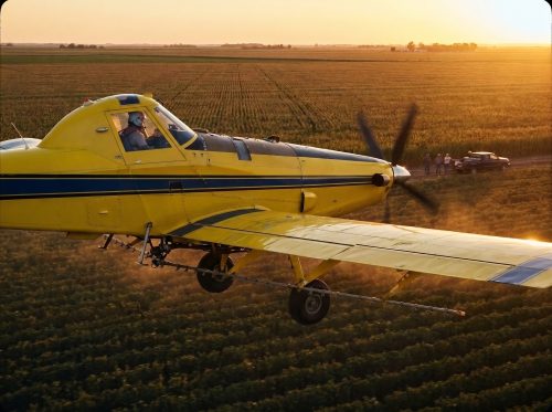 Crop_duster_flying_over_field_202608181709